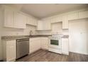Bright kitchen features white cabinetry, stainless steel dishwasher, and a modern countertop at 612 Muskrat Dr, Kissimmee, FL 34759