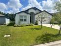 Inviting single-story home with lush green lawn and manicured landscaping at 6316 Dolostone Dr, Lakeland, FL 33811