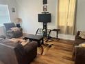 Cozy living room with hardwood floors and comfortable, neutral-toned furniture at 6316 Dolostone Dr, Lakeland, FL 33811