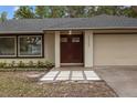 Close-up of house featuring a double door entry and two-car garage at 6320 Newman E Cir, Lakeland, FL 33811