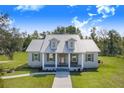 Inviting home with a metal roof, dormers, and a covered porch at 6344 Old Lake Wilson Rd, Davenport, FL 33896