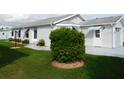 Well-maintained home with lush green lawn and beautiful landscaping at 6398 Lolly Bay Ne Loop, Winter Haven, FL 33881