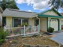 A well-maintained single story home with a small porch, updated roof, and solar panels at 9430 Daney St, Gotha, FL 34734