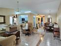 Spacious living room with tile flooring, chandelier lighting, and an open layout at 9430 Daney St, Gotha, FL 34734