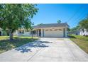 Well-maintained single-story home with a large driveway and an attached two-car garage at 109 Pasco Se Rd, Winter Haven, FL 33884