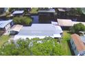 Aerial view of the home and adjacent waterways, showing the metal roof and surrounding trees at 117 Bream St, Haines City, FL 33844