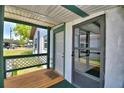 Inviting porch featuring a screen door, 'Welcome' mat and wood deck with green trim at 117 Bream St, Haines City, FL 33844