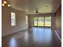 Spacious living room featuring light wood floors and sliding glass doors with access to the backyard at 1224 Vienna Square Dr, Winter Haven, FL 33884