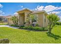 Attractive single-story home featuring a manicured lawn, an attached two-car garage, and a welcoming entrance at 132 Dinner Lake Ave, Lake Wales, FL 33859
