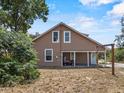 Exterior of a two-story home with a covered carport, swing, and a well-maintained yard at 134 Masterpiece Rd, Lake Wales, FL 33898