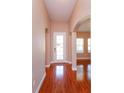 Inviting entryway with gleaming hardwood floors and arched doorways, offering a warm welcome at 135 Eloise Oaks Dr, Winter Haven, FL 33884