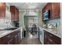 Open-concept kitchen and dining area featuring modern appliances and wood cabinets at 1610 Reynolds Rd # 242, Lakeland, FL 33801