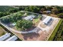 Expansive aerial view of a property with home, pool, outbuildings, and agricultural fields at 1646 Tyner Rd, Haines City, FL 33844