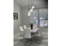 Elegant dining room featuring modern lighting and a stylish table setting at 1681 Waterview Loop, Haines City, FL 33844