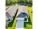 An aerial shot of several homes showing roof lines, driveways and landscaping at 1760 Carnostie Rd, Winter Haven, FL 33884