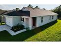 Side view of a home featuring a landscaped yard and attached one-car garage at 1760 Carnostie Rd, Winter Haven, FL 33884