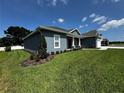 Well-maintained home featuring manicured landscaping, a brick accent wall, and a lush, green lawn at 1781 Lakehill Dr, Winter Haven, FL 33884