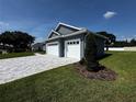 Beautiful home showcasing a two-car garage, paved driveway, and lush green lawn on a sunny day at 1781 Lakehill Dr, Winter Haven, FL 33884