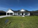 Charming single-story home featuring a well-manicured lawn and a two-car garage at 1787 Lakehill Dr, Winter Haven, FL 33884