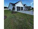 Charming home showcasing a manicured lawn and an attached two-car garage with a paved driveway at 1787 Lakehill Dr, Winter Haven, FL 33884