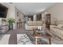 Spacious living room featuring carpet floors, recessed lighting, and an open concept design to the kitchen at 225 Summershore Dr, Auburndale, FL 33823