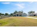 Charming single-story home with a well-manicured lawn and attached two-car garage at 230 Cove At Eagle Lake Cir, Eagle Lake, FL 33839