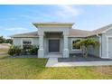 Inviting front entrance with a well-kept lawn, shrubbery and fresh exterior paint at 230 Cove At Eagle Lake Cir, Eagle Lake, FL 33839