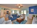 Open concept living room with stylish blue decor, tile flooring, and a ceiling fan at 2577 Canyon Crest Dr, Lakeland, FL 33811