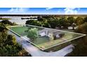 Aerial view of the property showcasing its proximity to the lake and its spacious lot with lush greenery at 302 W Gates Ave, Lake Hamilton, FL 33851