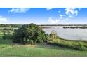 Expansive backyard with green grass and mature trees, providing a serene and private outdoor space next to the lake at 302 W Gates Ave, Lake Hamilton, FL 33851