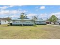 Beautiful home featuring well maintained yard and landscaping, and modern light blue metal roof at 317 Oak Trl, Lakeland, FL 33813