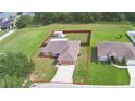 Aerial view of a single-Gathering home with a large, fenced backyard and a storage shed at 3430 Hilson Dr, Lakeland, FL 33812
