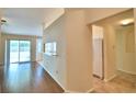 Bright living room featuring wood floors, sliding glass doors, and a kitchen view at 3430 Hilson Dr, Lakeland, FL 33812