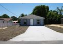 Charming single-story home featuring a freshly painted exterior, a new roof, and a neatly paved driveway at 3434 Avenue E Nw, Winter Haven, FL 33880