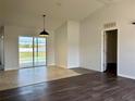 Bright living area featuring tile and wood flooring with sliding glass doors leading to the pool at 351 Columbo St, Winter Haven, FL 33880