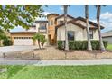 Charming two-story home with a circular tower and a three-car garage with manicured landscaping at 3833 Bowfin Trl, Kissimmee, FL 34746