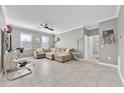 Bright living room featuring tile floors, neutral walls, and comfortable seating at 3853 Cortland Dr, Davenport, FL 33837