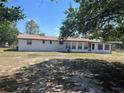 The back exterior features a spacious yard and numerous windows for ample natural light at 3949 Millstone St, Lake Wales, FL 33898