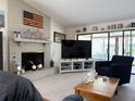 Comfortable living room featuring a brick fireplace, a large TV, and sliding glass doors to the outside at 4007 Cypress Lndg S, Winter Haven, FL 33884