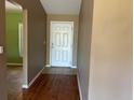 Inviting foyer with wood flooring and views of a room with green walls at 403 Se 3Rd St, Fort Meade, FL 33841