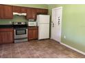 Functional kitchen with stainless steel appliances, tile floor, and oak cabinets at 403 Se 3Rd St, Fort Meade, FL 33841