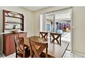Cozy dining area with wood table, chairs, and slider door access to the screened-in pool at 419 Broward Ter, Winter Haven, FL 33884