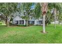 Charming lakeside home featuring a screened-in porch and beautiful mature trees at 4365 Canal Rd, Lake Wales, FL 33898