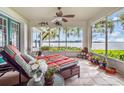 Relaxing screened-in porch with lake views, comfortable seating, and potted plants at 4365 Canal Rd, Lake Wales, FL 33898