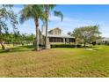 Well-maintained two-story home with mature trees, a green lawn, and a classic facade at 501 Main St, Lake Hamilton, FL 33851