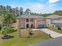 Charming two-story home boasts a well-kept lawn and an attached two-car garage at 524 Nogales, Kissimmee, FL 34758