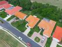 Aerial view showcases the home's tile roof, neat landscaping, and proximity to a tree lined street at 530 Greenway Dr, Lake Wales, FL 33898