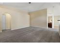 Expansive living area with an open layout, neutral carpet, and doorway to the bedroom at 533 Ronshelle Ave, Haines City, FL 33844