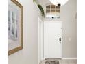 Bright entryway featuring tile floors, and decor accents, including a decorative painting and transom window above the front door at 662 Orista Dr, Davenport, FL 33897