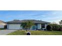 Charming single-story home features a well-maintained front yard and a lovely blue door at 716 Maderia Ct, Kissimmee, FL 34758